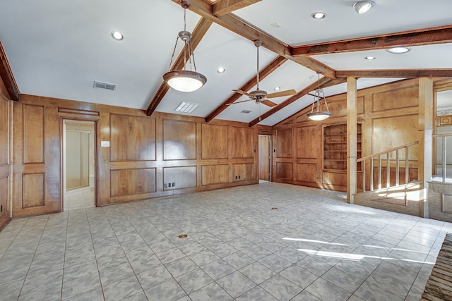 unfurnished room with visible vents, built in features, lofted ceiling with beams, ceiling fan, and wood walls