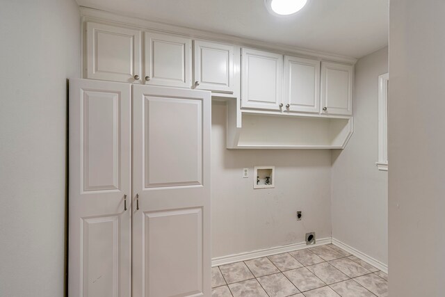 laundry area featuring light tile patterned floors, cabinet space, baseboards, washer hookup, and electric dryer hookup