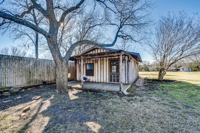 exterior space with an outbuilding and fence