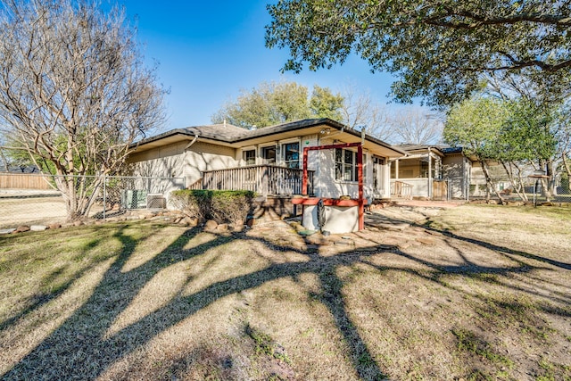 view of front of property with a front yard, brick siding, and fence