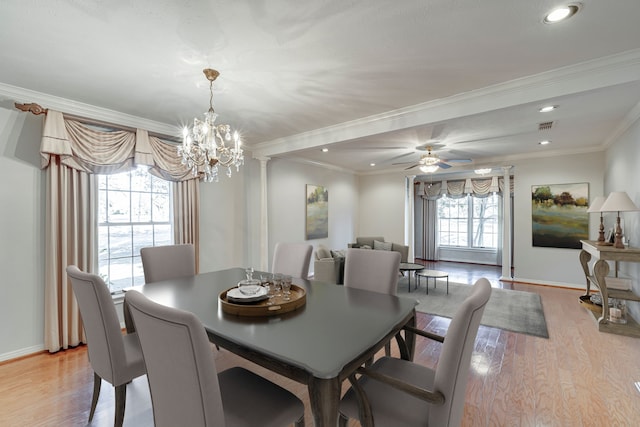 dining space featuring light wood-type flooring, ornate columns, baseboards, and crown molding