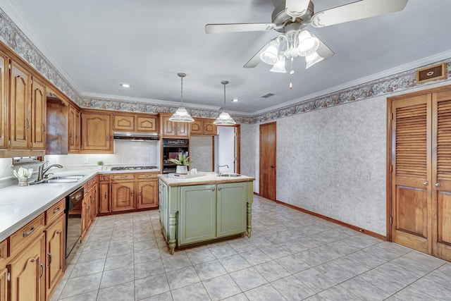 kitchen featuring a sink, a kitchen island, light countertops, black appliances, and pendant lighting