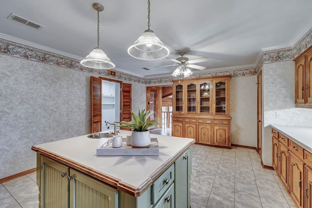 529 N Grand Ave, Waxahachie, TX 75165 - kitchen featuring a sink, a center island with sink, ceiling fan, light countertops, and decorative light fixtures