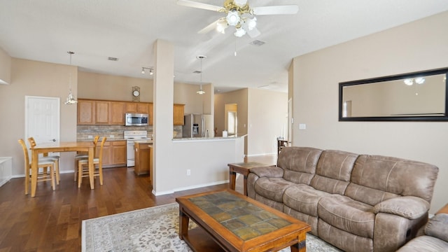 living room featuring visible vents, baseboards, dark wood-style floors, and a ceiling fan