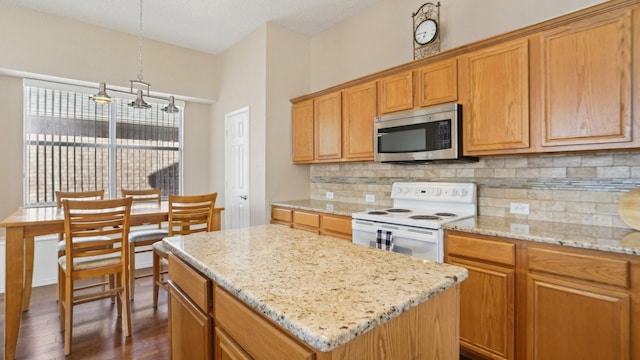 kitchen featuring stainless steel microwave, a center island, decorative backsplash, electric stove, and dark wood-style flooring