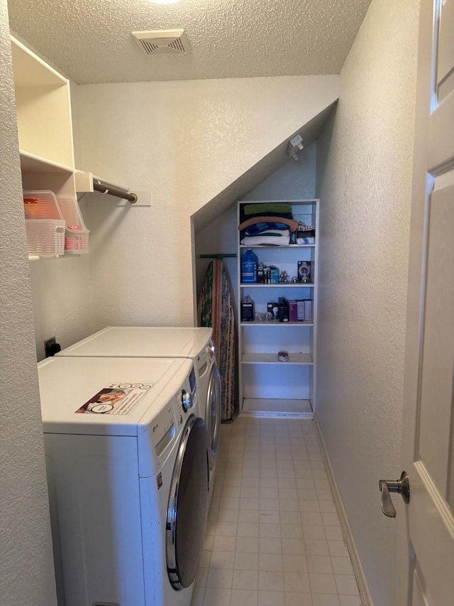 laundry area featuring independent washer and dryer and a textured ceiling