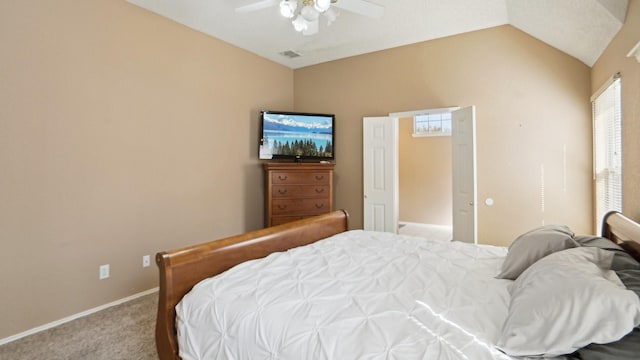 bedroom featuring a ceiling fan, visible vents, baseboards, lofted ceiling, and carpet flooring