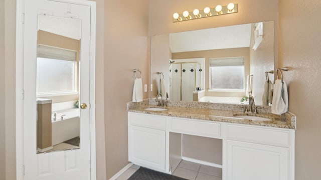 bathroom with a bath, a stall shower, double vanity, and a sink