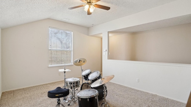 sitting room with ceiling fan, lofted ceiling, carpet, and a textured ceiling