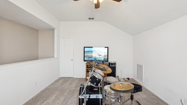 recreation room featuring visible vents, a ceiling fan, lofted ceiling, and carpet