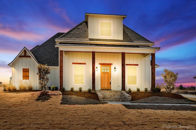 view of front of house featuring a shingled roof, a porch, and board and batten siding