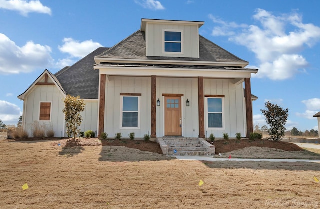 view of front of home featuring covered porch, board and batten siding, and roof with shingles