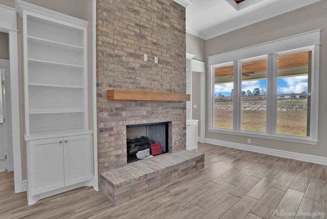 unfurnished living room with a brick fireplace, wood tiled floor, baseboards, and crown molding