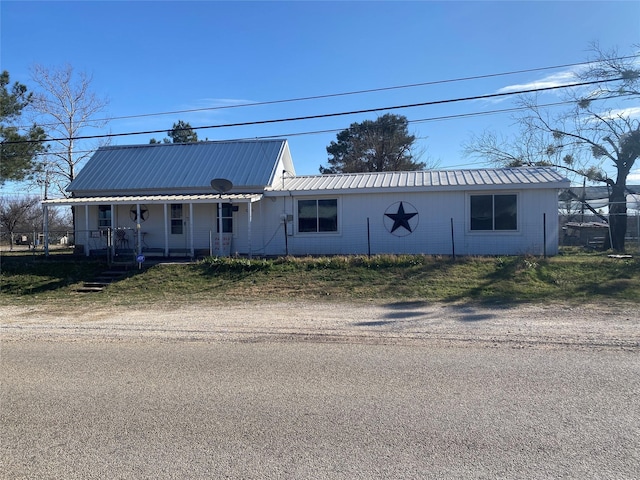 view of front of home with a porch and metal roof