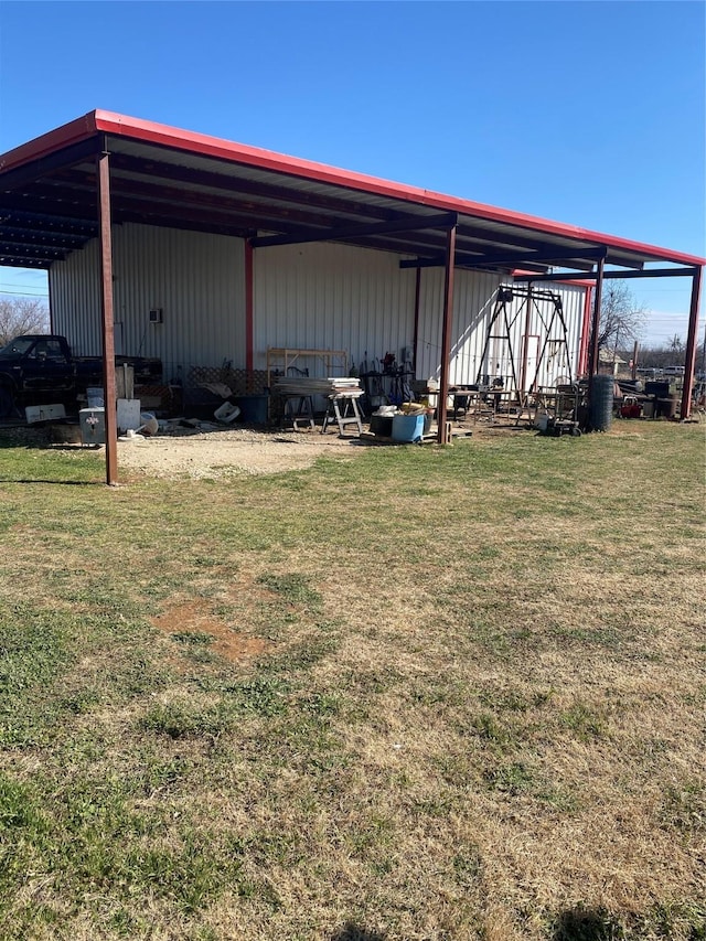 exterior space featuring a pole building, a carport, and an outdoor structure