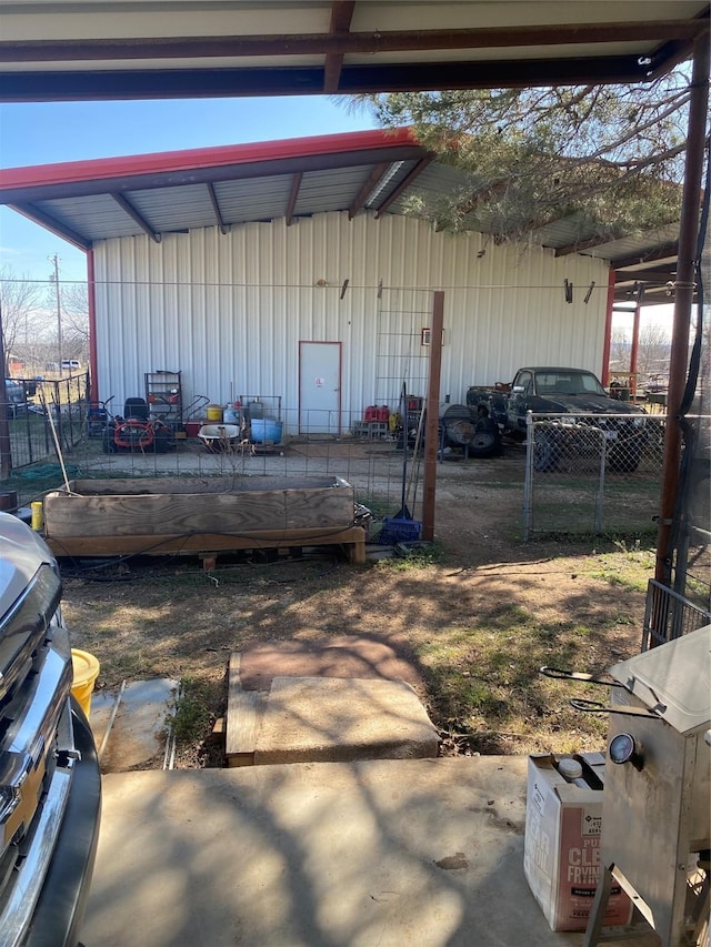 view of outbuilding featuring fence