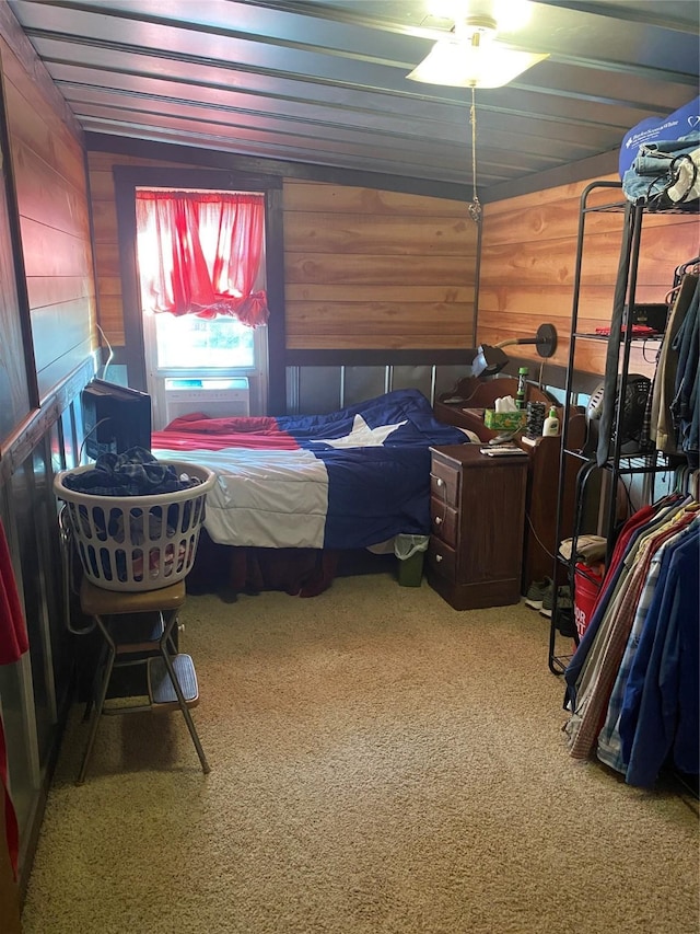 bedroom featuring carpet floors and wood walls