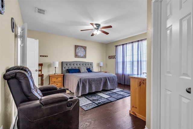 bedroom with ceiling fan, dark wood-type flooring, and visible vents