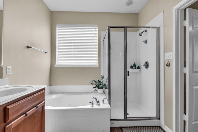 full bath featuring a shower stall, a bath, and vanity