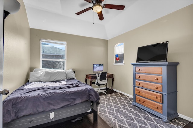 bedroom with ceiling fan, dark wood-style floors, and baseboards