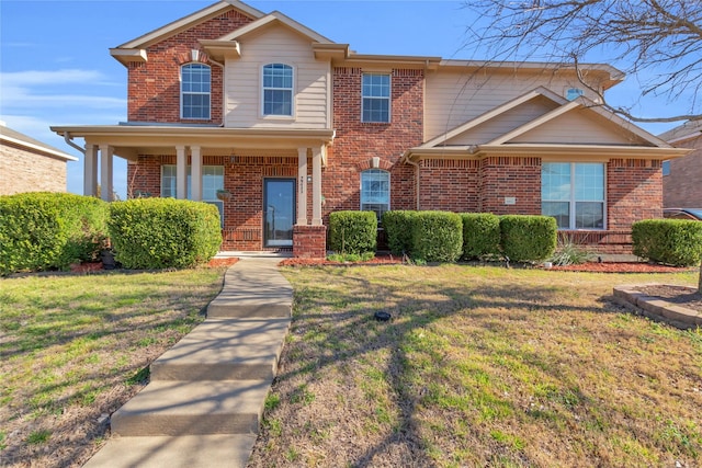 traditional-style house featuring brick siding and a front lawn