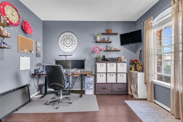 home office with baseboards and wood finished floors