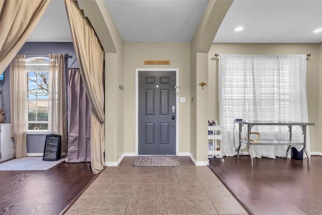 entryway with recessed lighting, wood finished floors, and baseboards