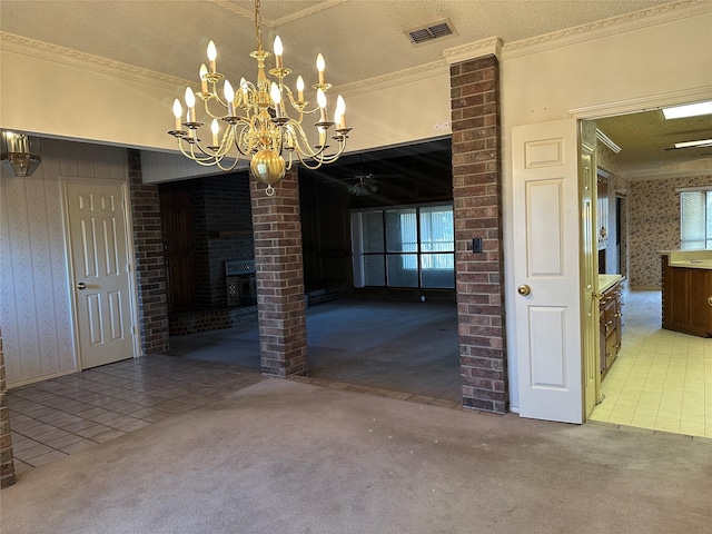 unfurnished dining area with light carpet, wallpapered walls, visible vents, crown molding, and a fireplace