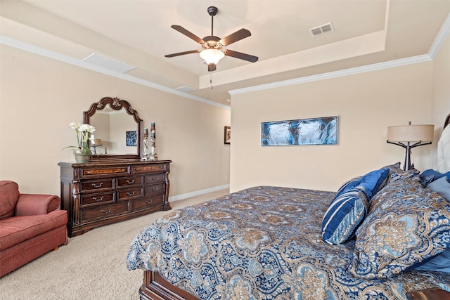 carpeted bedroom featuring visible vents, a ceiling fan, a raised ceiling, and crown molding