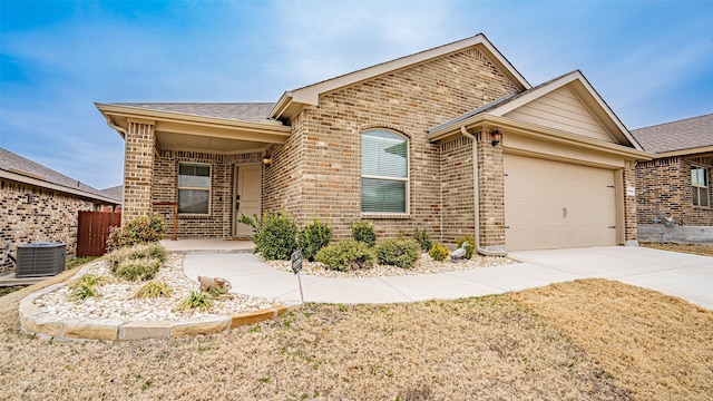 9912 Huntersville Trl, Fort Worth, TX 76108 - ranch-style home featuring a garage, driveway, central AC unit, roof with shingles, and brick siding
