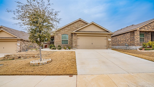 ranch-style home with a garage, driveway, and brick siding