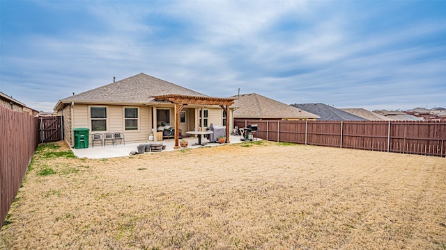 back of house with a patio, a fenced backyard, a yard, roof with shingles, and a pergola