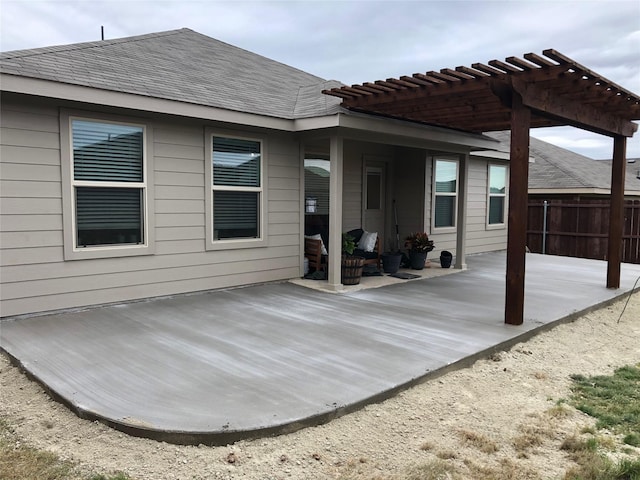 exterior space with fence, a pergola, and a patio