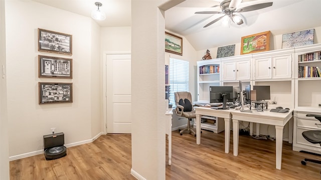 office space featuring ceiling fan, vaulted ceiling, light wood-style flooring, and baseboards