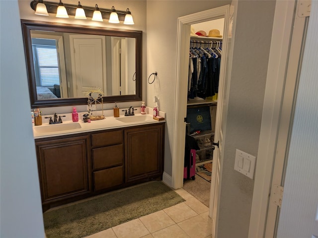 4248 Old Timber Ln, Fort Worth, TX 76036 - bathroom with double vanity, a spacious closet, a sink, and tile patterned floors