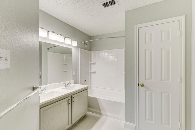 bathroom featuring bathtub / shower combination, a textured ceiling, visible vents, and a sink