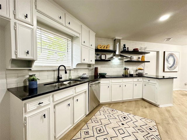 kitchen with white cabinets, dishwasher, dark countertops, open shelves, and a sink