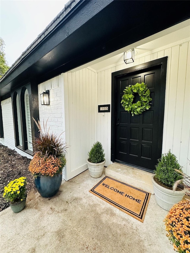 entrance to property featuring brick siding