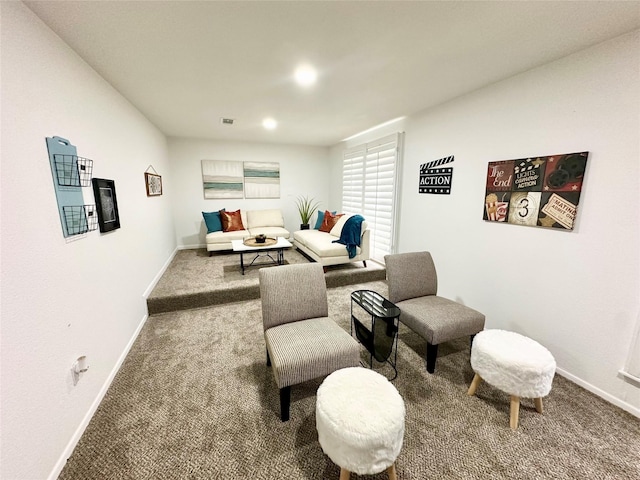 carpeted living area featuring visible vents and baseboards