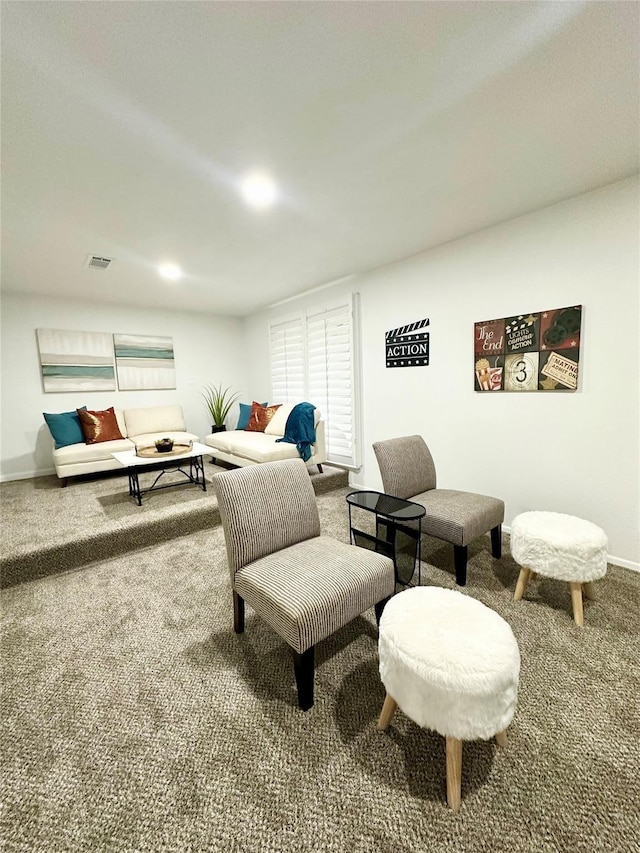 carpeted living area with visible vents and baseboards