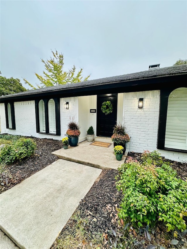 property entrance with brick siding