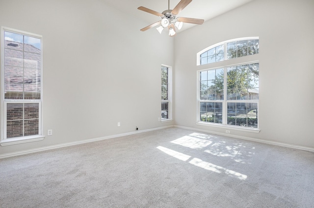 spare room with a healthy amount of sunlight, carpet, and baseboards