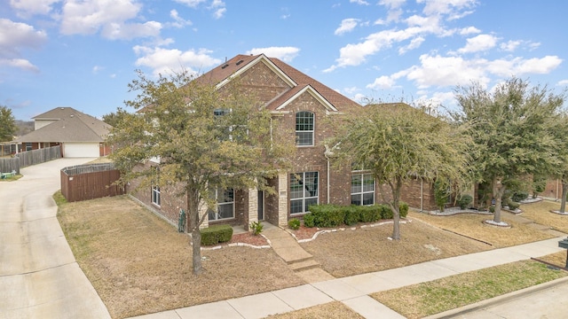 view of front of house featuring fence and brick siding