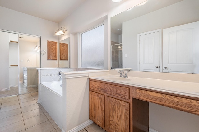 full bathroom with a garden tub, vanity, a stall shower, and tile patterned floors