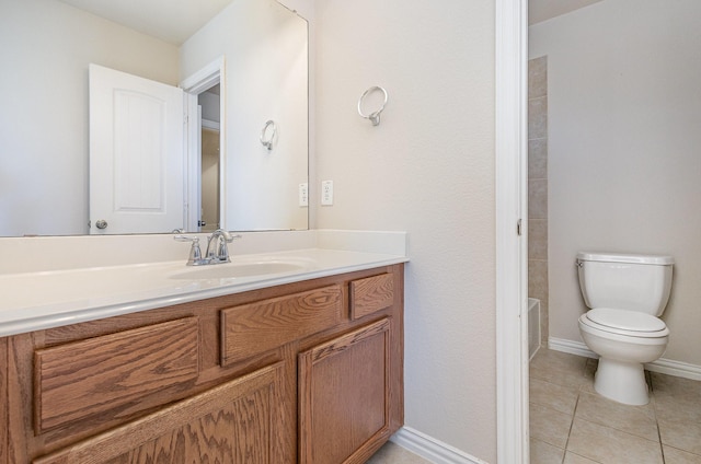 bathroom featuring tile patterned flooring, baseboards, vanity, and toilet