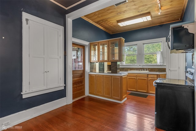 kitchen with visible vents, electric stove, glass insert cabinets, wood finished floors, and light countertops