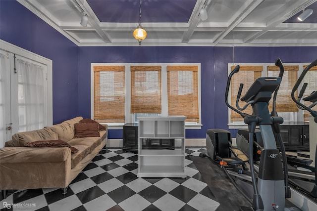 exercise area with dark floors, coffered ceiling, and baseboards