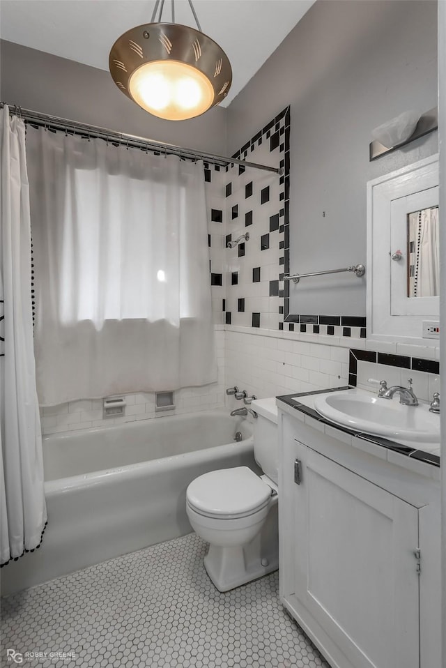 full bathroom featuring tile walls, toilet, shower / tub combo, vanity, and tile patterned floors