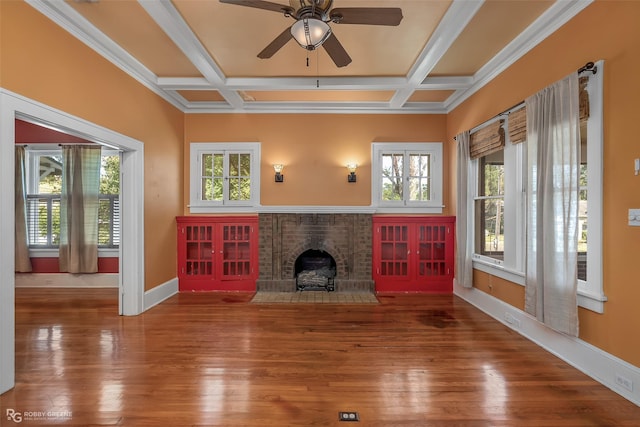 unfurnished living room with beam ceiling, a fireplace, wood finished floors, coffered ceiling, and baseboards