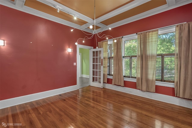 spare room featuring coffered ceiling, wood finished floors, baseboards, beam ceiling, and rail lighting